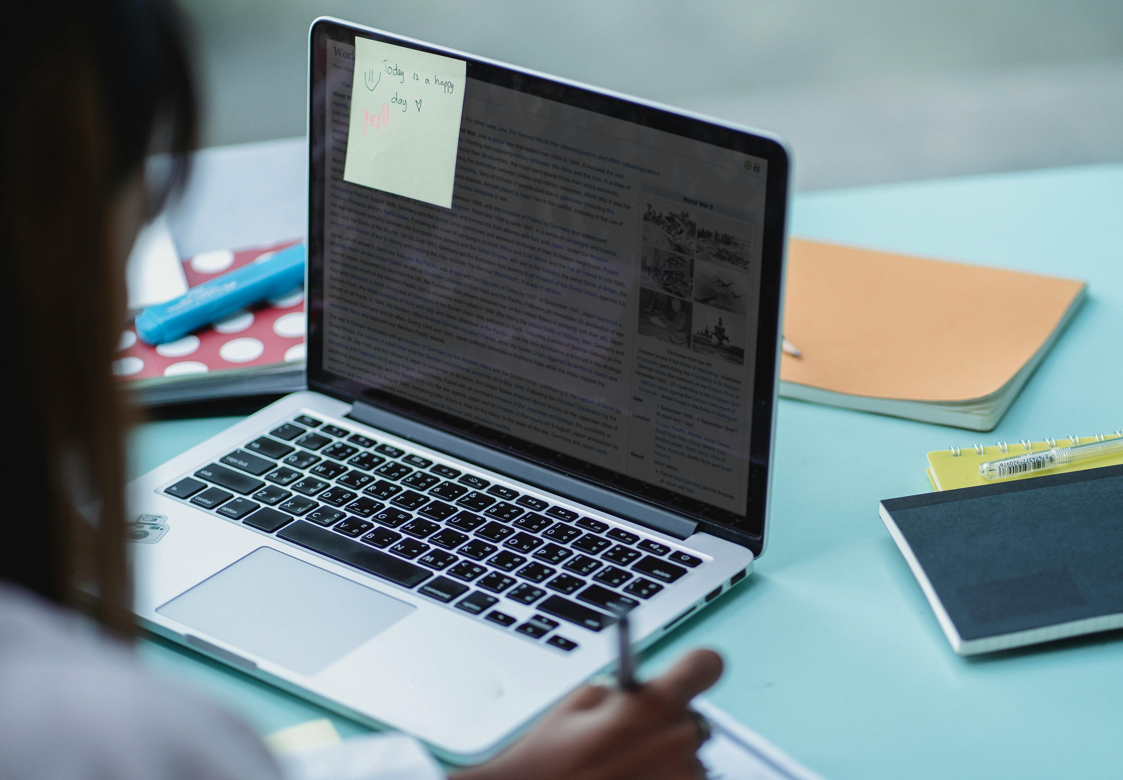 Student using a laptop for AI-assisted learning at a study desk